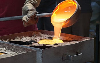 Pouring hot glass into metal